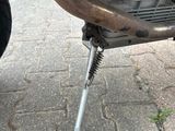 a close up of a motorcycle with a tire on the ground