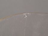 a clear bowl with toothbrushes in it on a table
