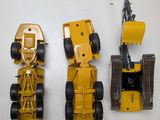 three toy vehicles sitting next to each other on a table