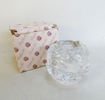 an image of a clear glass apple sitting next to a box