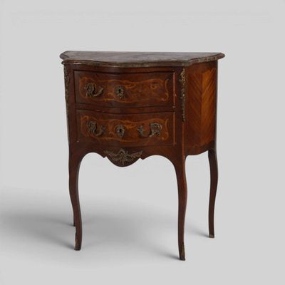 an old wooden chest of drawers with a marble top