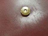 a brown leather bag with a gold button on it