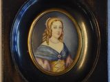 portrait of a woman in a blue dress in a black and gold frame