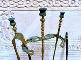 three candles that are sitting on a stand in front of a wall