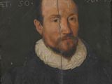 portrait of a man with a beard in a black coat and white collar