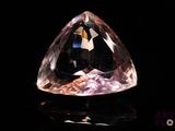 an image of a very pretty pink diamond on a black surface