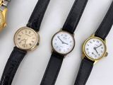 three different types of watches are displayed on a white surface