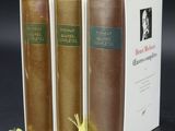 three books sitting on top of a table next to each other