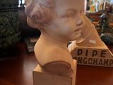 a statue of a woman sitting on a table
