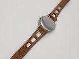 a close up of a watch on a white surface