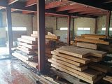several pieces of wood are stacked on the floor in a warehouse