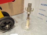 a wheel with a bolt on it sitting next to a box