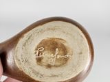 a person holding a wooden spoon with the word love you written on it