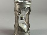 a silver cup that has a handle on it