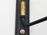 a close up of a wall mounted light with a black handle