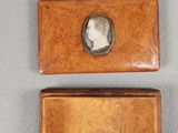 two small wooden boxes with a picture of a woman in profile