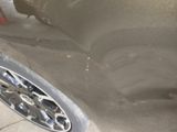 a close up of a car ' s paint job on the side of the road