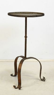 an image of a small table with a metal base and a circular top