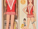 poupée Barbie dans une boîte, vêtue d'une tenue à rayures rouges et blanches