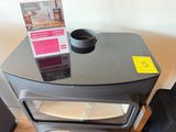 a small stove with a cup on top of it