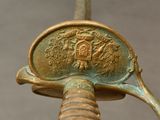 a close up of a metal object with a gold colored handle