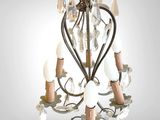 a small chandelier with a heart shaped light hanging from it