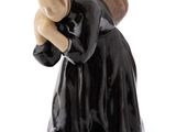 figurine of a woman in a black dress with a hat on her head