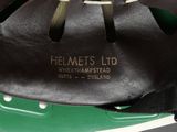 a close up of a black and green bicycle helmet