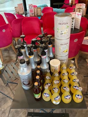 many bottles of juice on a table in a store