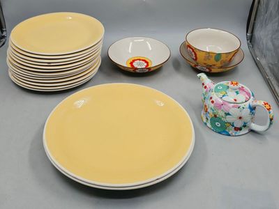 a lot of plates and cups on the counter