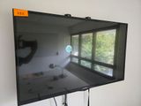 a flat screen tv on a stand in a room