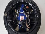 a black helmet with wires attached to it on a white surface