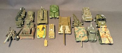 tout un tas de petits véhicules militaires de jouet posés sur une table