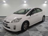 a picture of a white toyota prius parked on a checkered floor