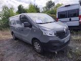 a grey van that is parked in the dirt