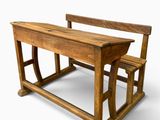 a wooden school desk and a chair on a white background