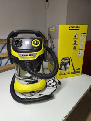 yellow and black vacuum cleaner sitting on top of a table next to a box