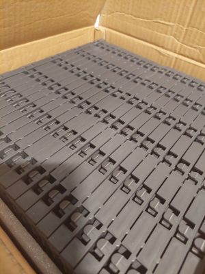 a box that has a bunch of black legos inside of it