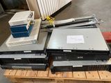 a pile of computer equipment sitting on a pallet in a warehouse