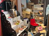 a room with a lot of clutter and boxes on the floor