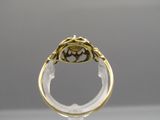 a close up of a gold ring with a brown stone in the center