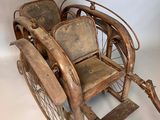 an old fashioned wooden sleigh with two wheels and a seat