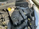 the engine of a car with its hood open and the hood down