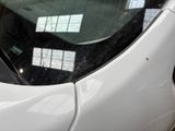 a close up of a car ' s rear window with a sticker on it