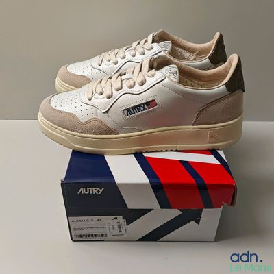 a pair of shoes that are on top of a box
