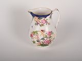 a white pitcher with a floral design on it