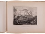 an open book with a picture of a mountain in the background