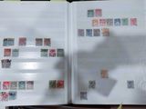 an open book with stamps on it sitting on a table