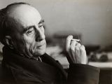 black and white photograph of a man holding a cigarette in his right hand