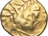 a gold coin with a head of a man on it